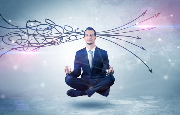 Businessman meditating, arrows going into his head chaotically and coming out in an orderly fashion