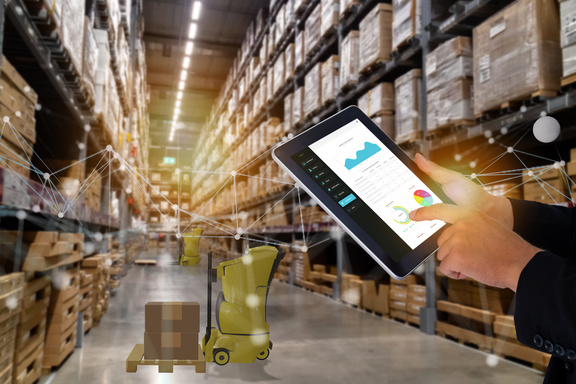 Person with ERP system on the tablet in a warehouse