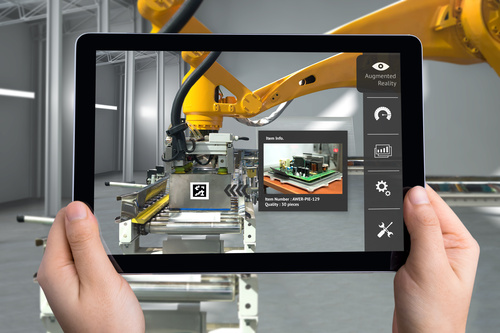 A tablet shows the image of an industrial production robot and the digital data from the system